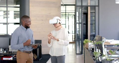 Businesswoman Using VR Headset While Collaborating in Modern Office