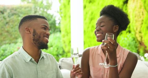 Couple Celebrating with Champagne Outdoors