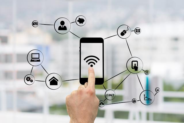 Hand using smartphone with various network connection icons showcasing data, internet, and technology. Useful for illustrations on network technology, digital communication, and modern tech advancements.