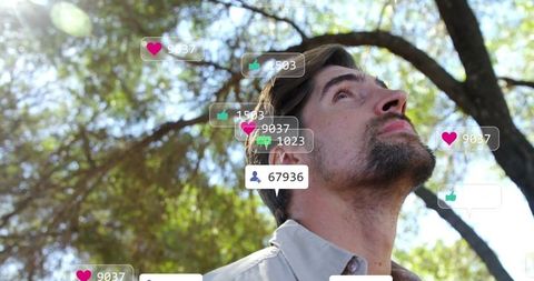 Man in Sunlit Park Analyzing Social Media Overlays with Nature Around