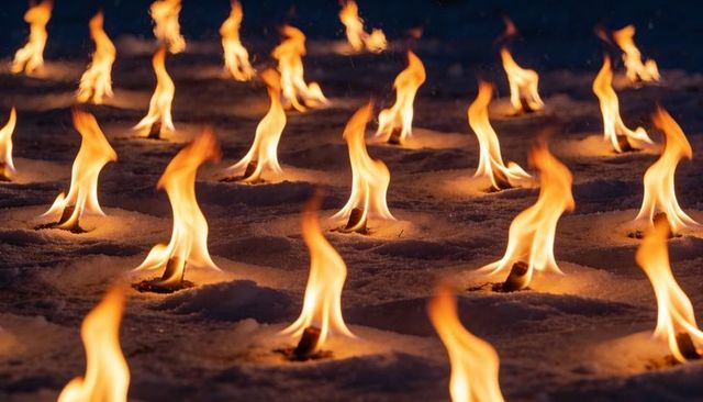 Glowing flames burning on snow in repetitive grid night for dramatic contrast