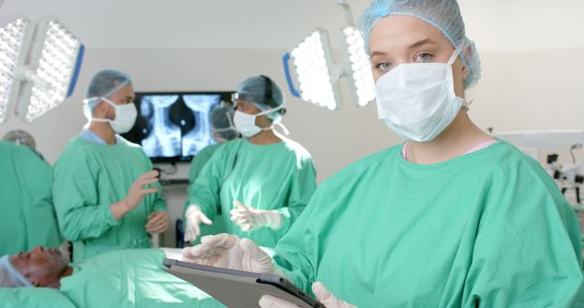 Surgeons Collaborating in Operating Room While Doctor Using Tablet - Download Free Stock Images Pikwizard.com