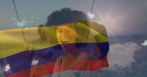 Joyful Woman Celebrating with Sparkler at Sea During Sunset