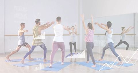 Instructor leading group fitness class practicing lunge poses on blue mats in mirror studio