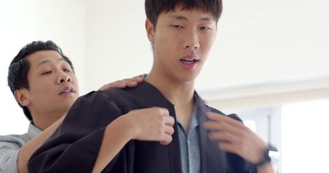 Friends Preparing for University Graduation Ceremony