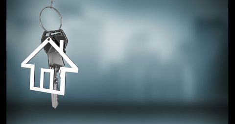 Silver house keys hanging symbolizing real estate and home ownership