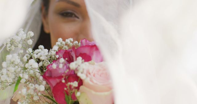 Bride holding a vibrant bouquet of pink, white, and red roses. Perfect for wedding blogs, bridal fashion, love-themed advertisements, and romantic event marketing.