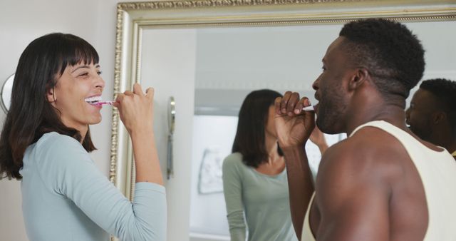 Happy Multiracial Couple Brushing Teeth Together in Bathroom Mirror - Download Free Stock Images Pikwizard.com