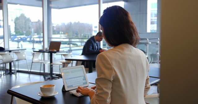 Businesswoman Working on Tablet in Modern Cafe - Download Free Stock Images Pikwizard.com