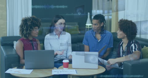 Diverse Team Discussing Financial Data in Tech Environment