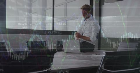 Executive Monitoring Stock Market Trends with Digital Interface