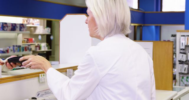 Pharmacist in White Coat at Pharmacy Counter Helping Customer - Download Free Stock Photos Pikwizard.com