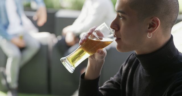 Young Man Enjoying Craft Beer on Outdoor Patio - Download Free Stock Images Pikwizard.com