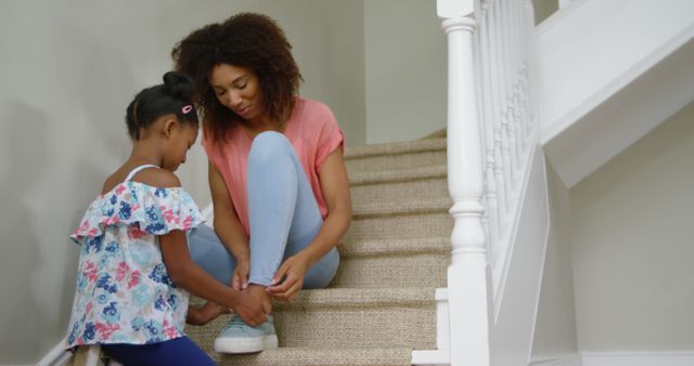 Loving Mother Helping Daughter with Shoes on Stairs - Download Free Stock Images Pikwizard.com