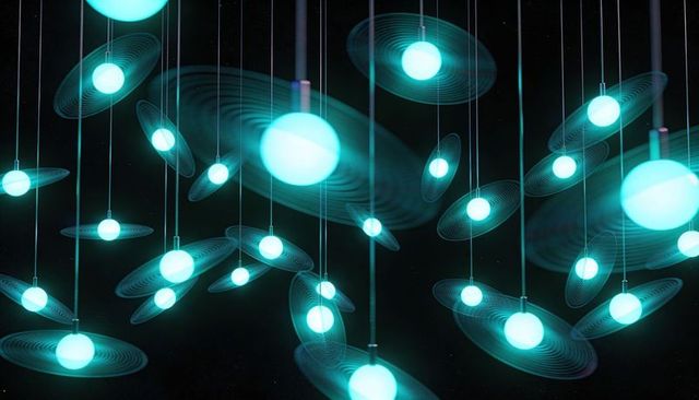 Glowing cyan orb pendant installation with concentric disc rings and thin cables