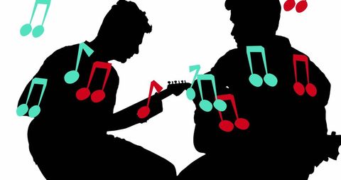 Silhouettes of Musicians Creating Melodic Harmony with Guitars
