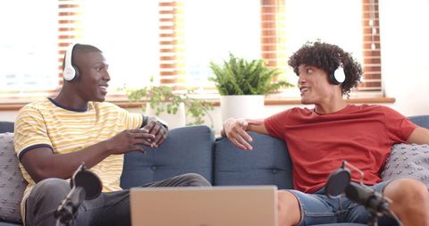 Diverse Friends Enjoying Podcast Recording on Comfortable Sofa