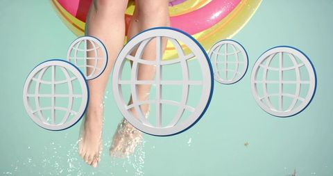 Relaxing on neon pool float dipping legs in turquoise water with global icons