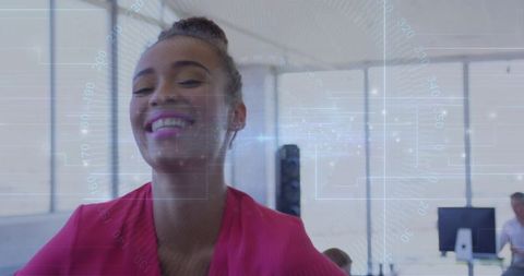 Smiling professional woman collaborating in bright open-plan office with HUD tech overlay