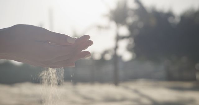 Hands Letting Sand Flow Through Fingers at Sunset - Download Free Stock Images Pikwizard.com