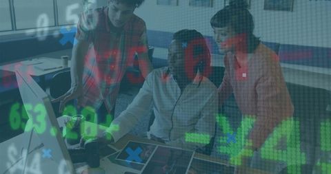 Creative team collaborating at desk with digital data overlay analyzing design analytics