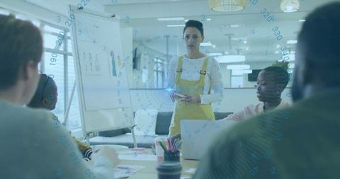 Businesswoman leading team discussion in modern office setting