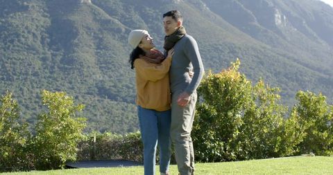 Couple Embracing Nature at Scenic Mountain Base