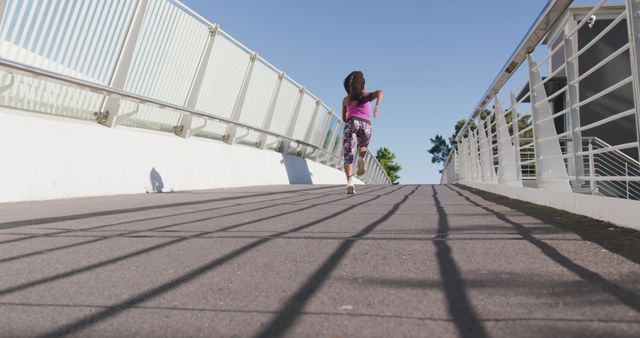 Woman Jogging on Urban Bridge in Sunny Weather - Download Free Stock Images Pikwizard.com