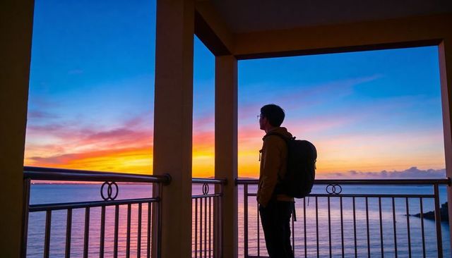 Traveler with backpack gazing at colorful ocean sunset from balcony silhouette at twilight