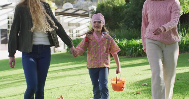 Happy Child Holding Bucket During Park Walk with Family - Download Free Stock Images Pikwizard.com