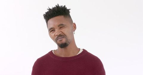 Confused man in red sweater expressing perplexity