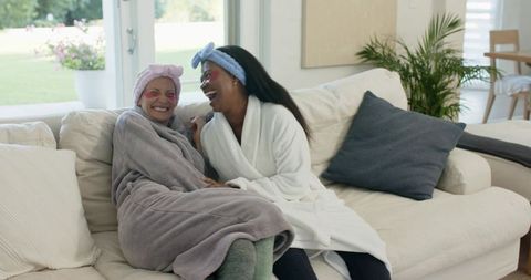 Diverse women relaxing and laughing in cozy home setting