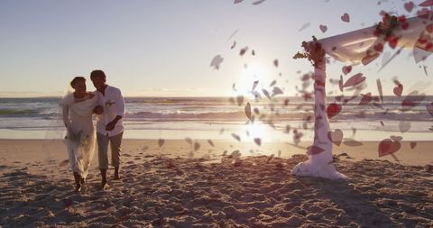 Romantic beach wedding with heart-shaped petals and sunset