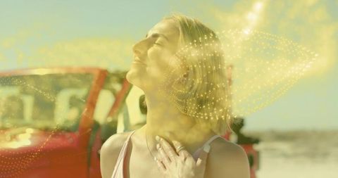 Woman Standing by Convertible with Energetic Golden Particles