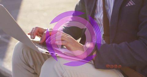 Business Professional Working Outdoors on Laptop Amidst City Environment