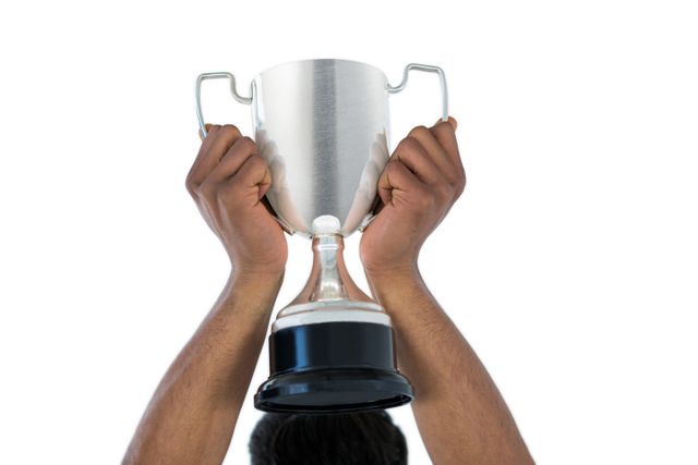 Hand of businessman lifting a trophy against white background