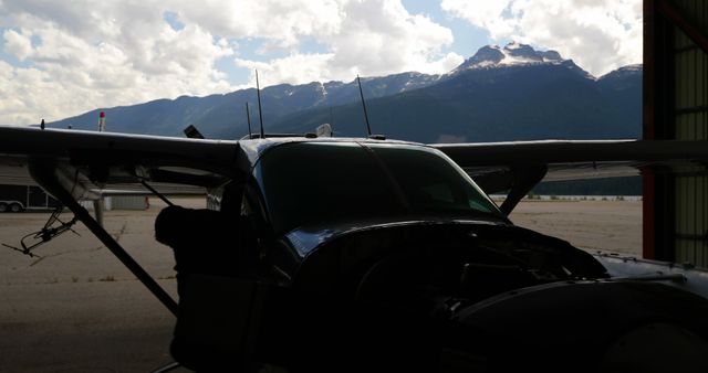 Small Aircraft in Hangar with Mountain Background at Sunrise - Download Free Stock Images Pikwizard.com