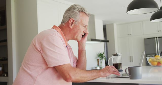 Caucasian senior man sitting in kitchen with coffee and having call - Download Free Stock Photos Pikwizard.com