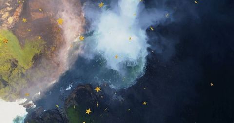 Aerial View of Waterfall Amidst Mossy Cliffs with Falling Stars