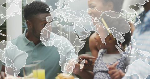 Multigenerational family sharing relaxed breakfast around table with world map overlay