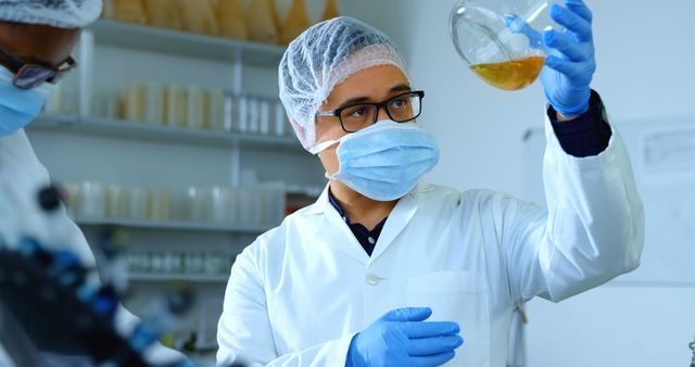 Scientist examining sample in laboratory with protective gear - Download Free Stock Images Pikwizard.com