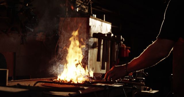 Blacksmith heating iron rod in fire 4k