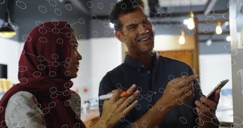 Modern Diverse Teams Collaborating with Technology in Office