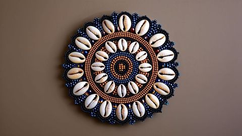Circular shell and bead mandala with cowrie shells and beads