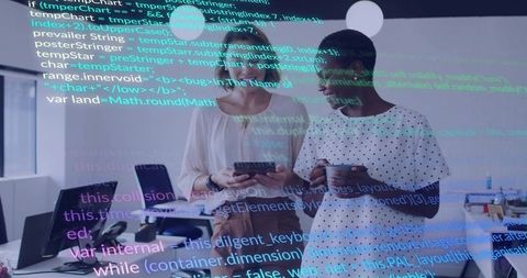 Two women collaborating with tablet and coffee, coding overlay in modern office workspace