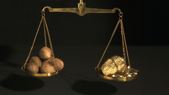 Golden balance scale holding gold nuggets on one side and spices on the other, contrasting the value of different commodities. Could be used for illustrating economic theories, trade concepts, comparative value in business articles, or financial blogs about market dynamics.