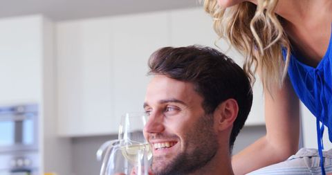 Happy Couple Drinking Wine Together in Modern Kitchen