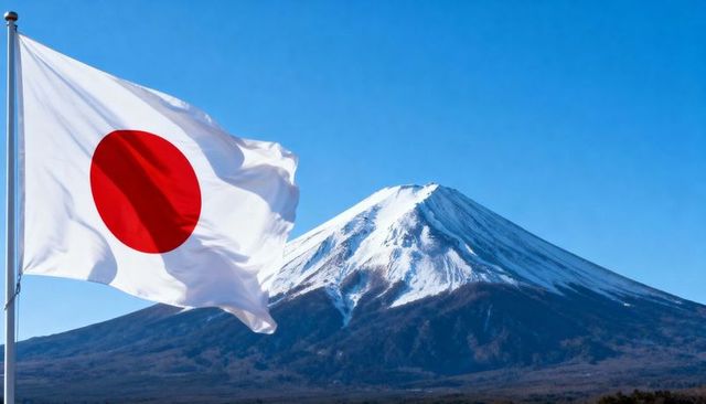 Japanese flag fluttering before snowcapped mount fuji with red sun disc on blue panorama