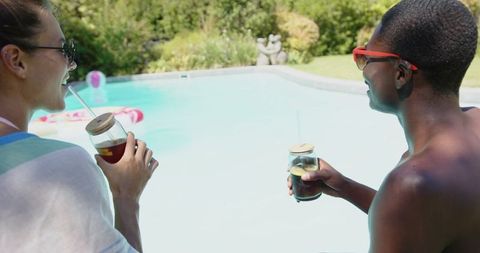 Diverse Couple Enjoying Drinks by Poolside on Sunny Day - Download Free Stock Images Pikwizard.com