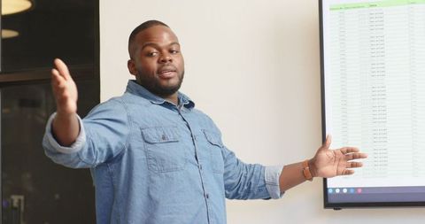 Confident Business Professional Presenting Data in Office Meeting